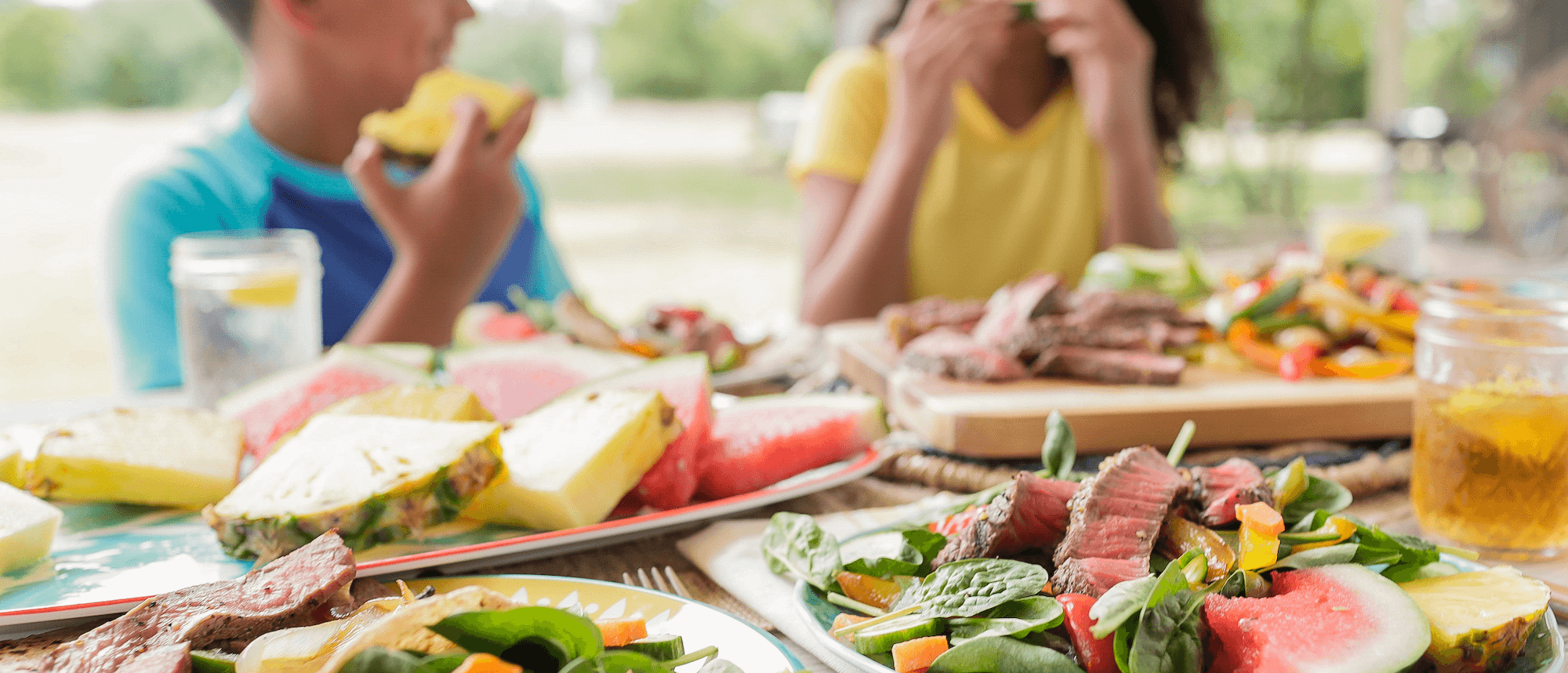 Kids enjoying fruit and beef salad