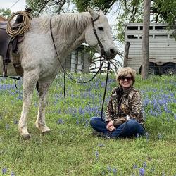 Molly on the ranch with her horse.